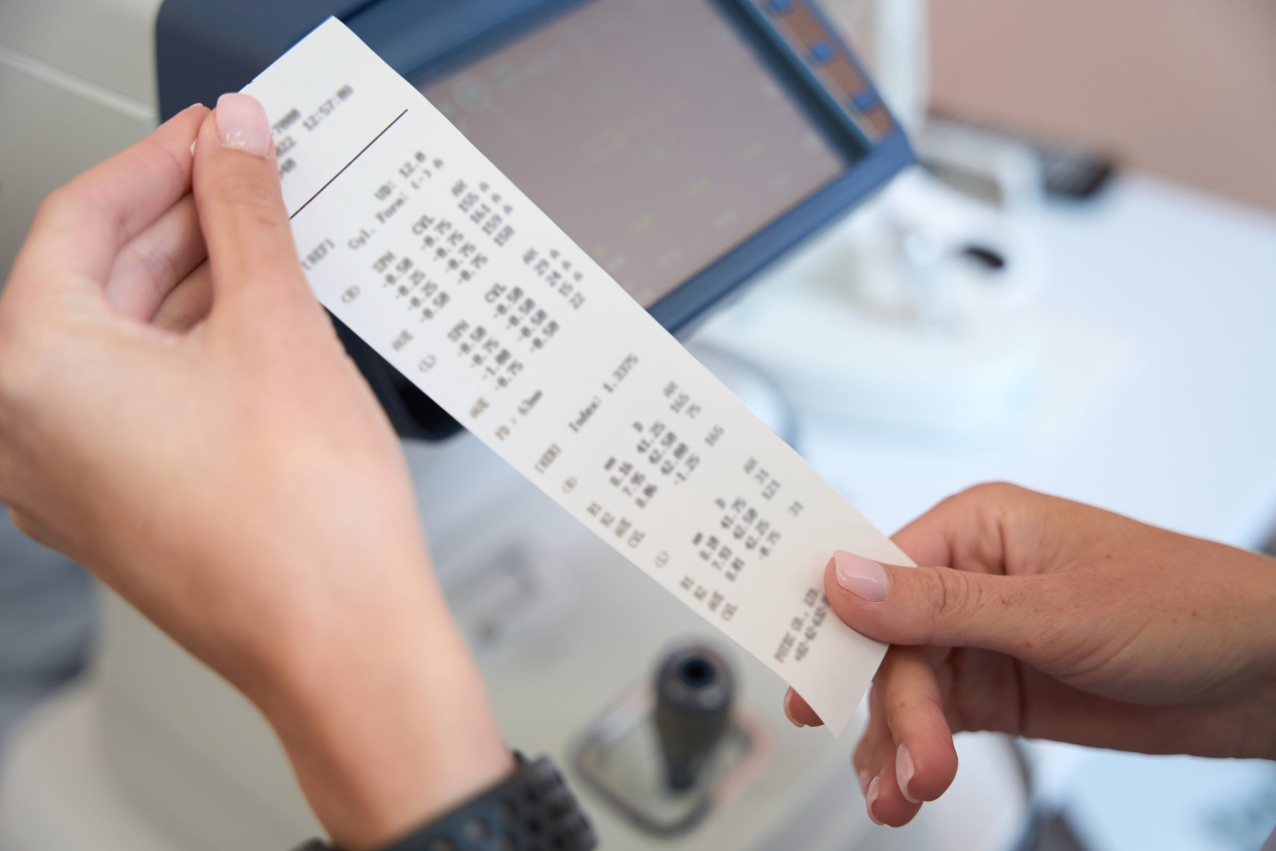 Close up portrait of female doctor is holding the result of examining eyesight with slit lamp in the ophthalmology center