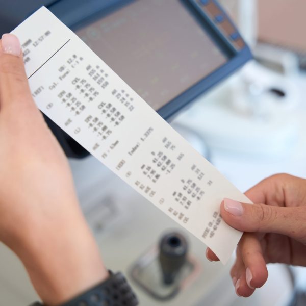 Close up portrait of female doctor is holding the result of examining eyesight with slit lamp in the ophthalmology center